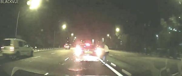 Taxi brakes suddenly on first lane to pick up passenger